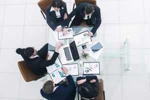 top view of successful business team discussing marketing schemes and financial schedules for the development of the company.the photo is a blank space for your text